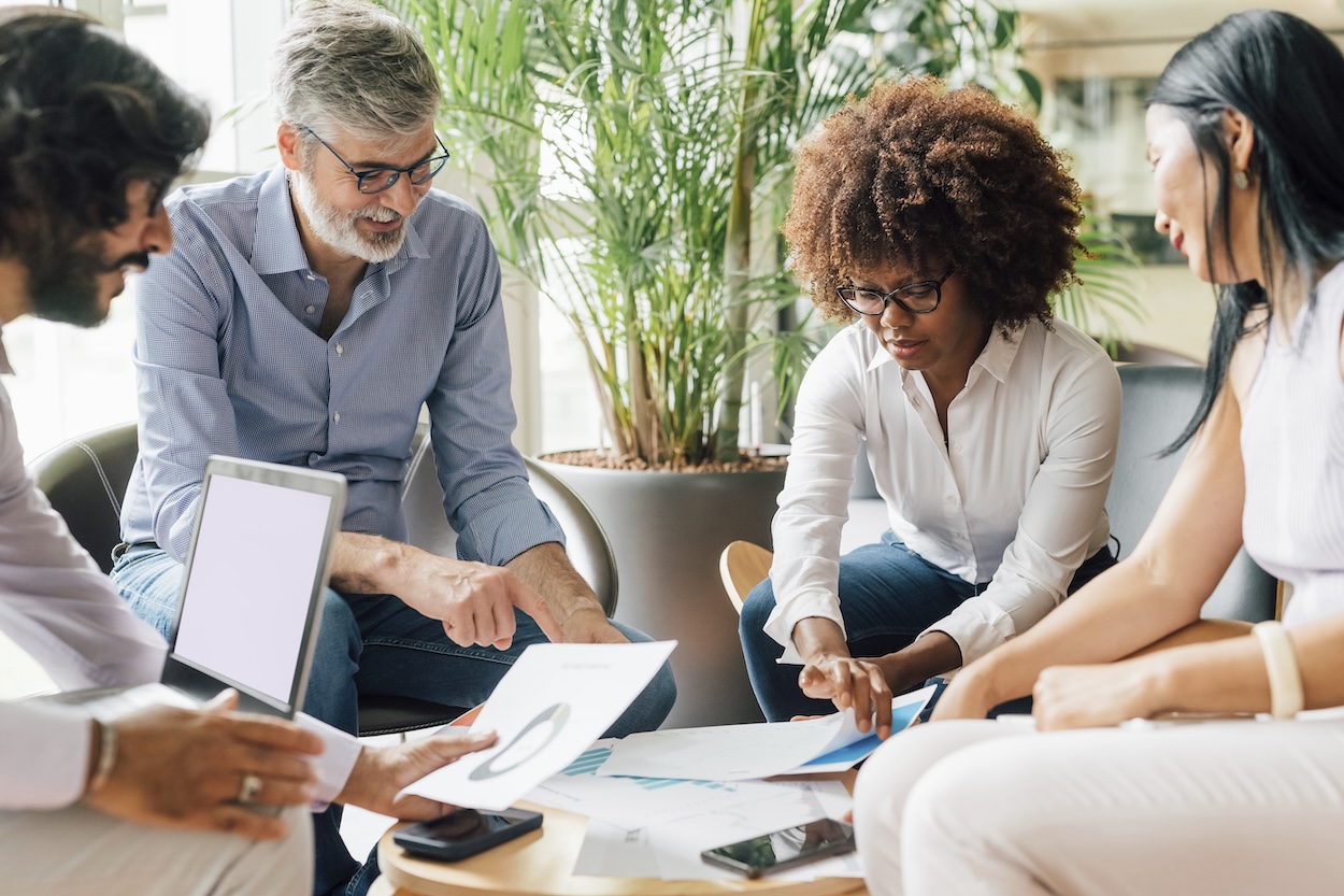 Several people sitting around, planning an HOA budget. 