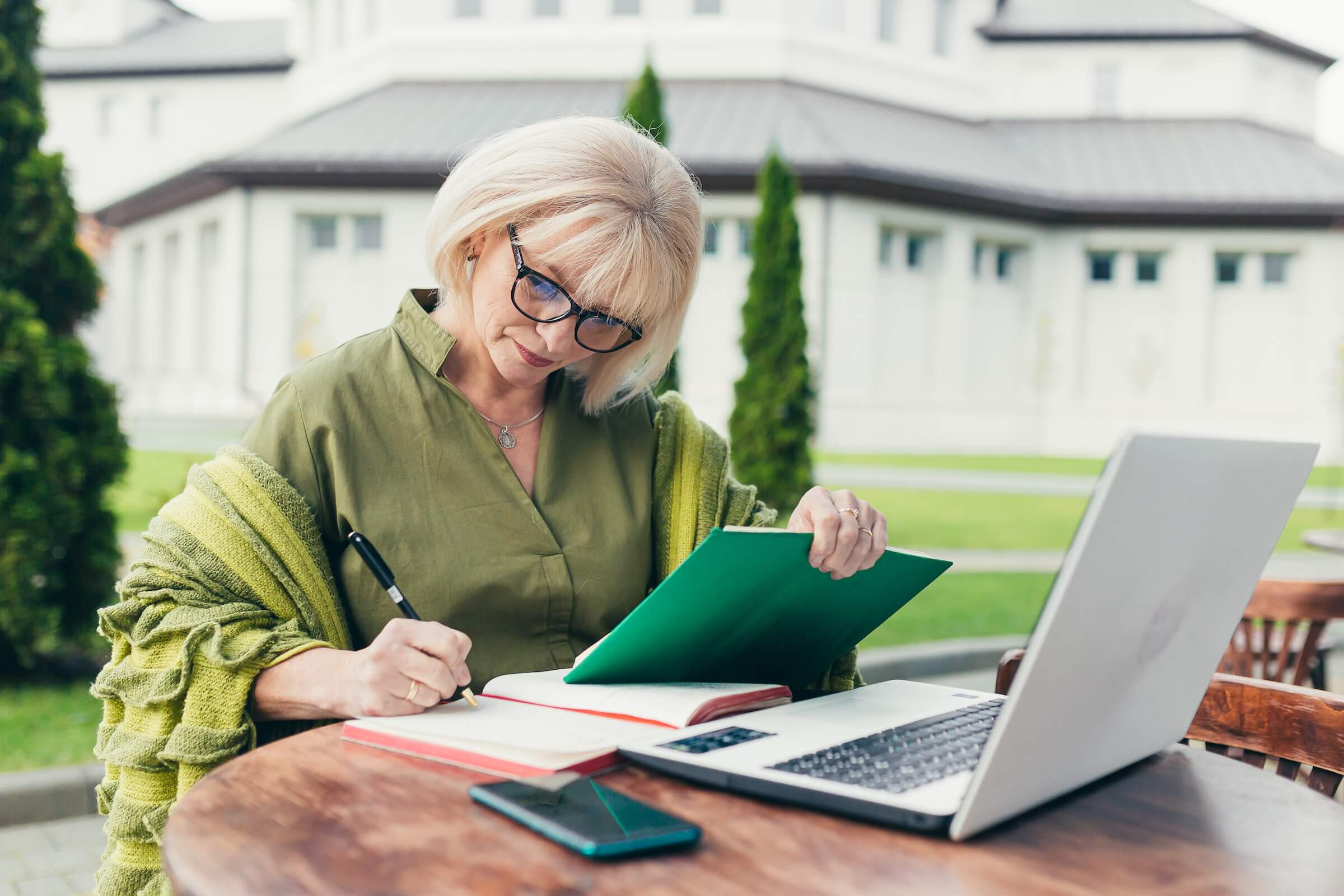Older female HOA board member taking notes